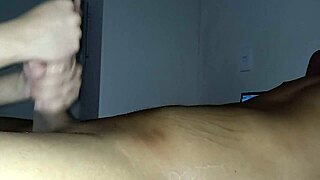Young black man's big cock gets a handjob from an interracial couple