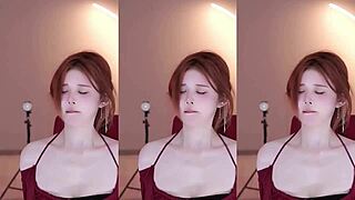Adorable girl with perfect breasts in a red dress performs hot dance