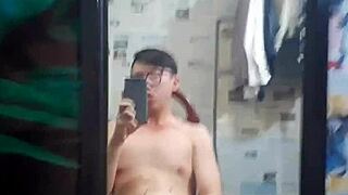 A Vietnamese gay man gives a blow job to a big cock