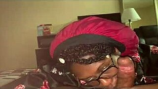 Young black girl wears glasses and gets a facial with a big black cock