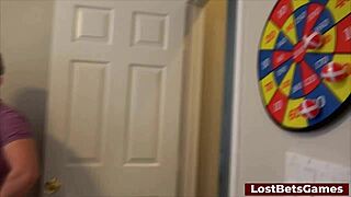 Two beautiful red-haired women and one man have sex in a bedroom while playing a strip darts game