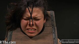 girl strips inside the cage, clothes ripping off