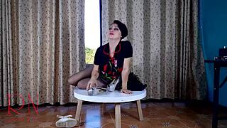 Brunette housewife undressing at a round table in stockings