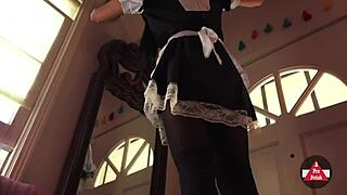 French maid in cosplay vacuums the house