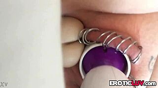 This horny babe works her pierced pussy with toys.