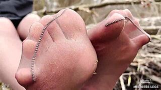 Hey, check this goddess teasing with feet in tan pantyhose outdoors