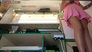 Voyeur cam catches hot babe in pink skirt flashing upskirt at work.