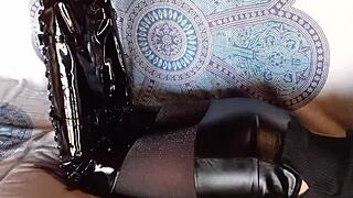 Petite amateur in total black lingerie fishnets pantyhose and over-the-knee boots shows ass