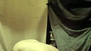 female slave in bdsm self-session with clamps and piss