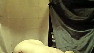 female slave in bdsm self-session with clamps and piss