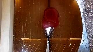 Girl with appetizing ass plays in shower using pink toy for fun.