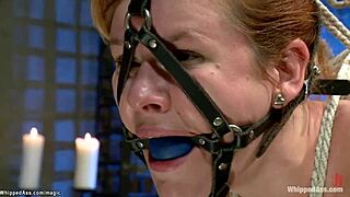 Dyke slave with big tits bound in bondage for ass spanking and whipping in lezdom fetish