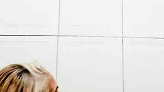 Blonde milf in bathroom uses dildo on pussy solo behind the scenes