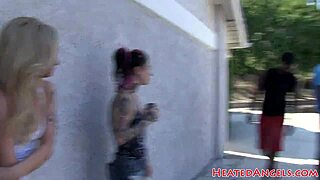 goth whores with tattoos and piercings chat backstage in bizarre emo punk style. they share comic behind the scenes stories casually.