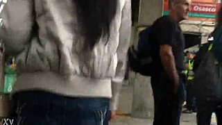 In the crowded train setting, a woman sports a casual jacket and sturdy boots during her daily commute. Part 1.