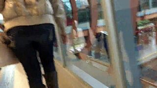 In the crowded train setting, a woman sports a casual jacket and sturdy boots during her daily commute. Part 1.