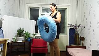 Milf engages in looner fetish by blowing and inflating the beach circle with big tits and ass.