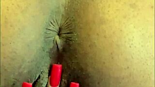 This hot ebony slut bends over to finger her shaved pussy and pierced clit.