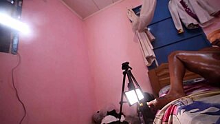 damn she's stroking that cameraman's cock while slamming dildo deep in her ebony pussy