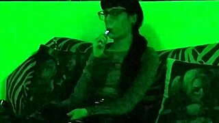 Beth's kinky goth domina smokes seductively in green light!