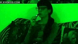 Beth's kinky goth domina smokes seductively in green light!