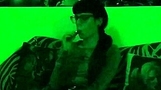 Beth's kinky goth domina smokes seductively in green light!
