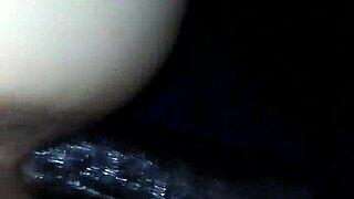 A diverse couple explores intimate connections in a shared moment.