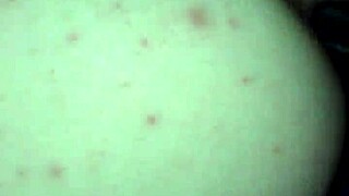 A diverse couple explores intimate connections in a shared moment.