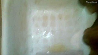 A guy jerks off while peeing and shoots his jizz everywhere.