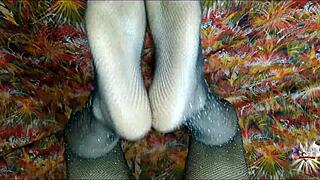 she jerks your cock with tattooed feet