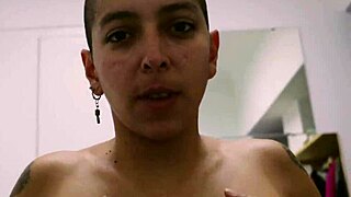 Short tattooed girl strips teasingly