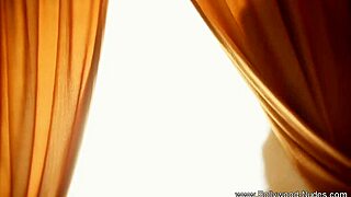Seductive striptease and erotic dance by a brunette bombshell