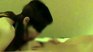 In a cozy bedroom, a beautiful Chinese girlfriend teases with handjob and blowjob. She brings him to climax.