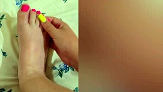 Young babe strokes sexy feet with pink pedicure