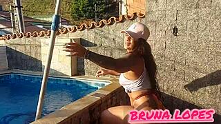Yo, check part 2 of Bruna in a pink bikini cleaning the pool, transparent top on, tell us the next bikini color!