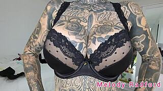 Melody Radford tries on black and purple lingerie and micro bikini.