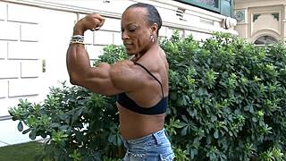 tall muscular bodybuilder women flex biceps in femdom session