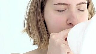 watch this young babe blow and pop her first balloon while giving a blowjob